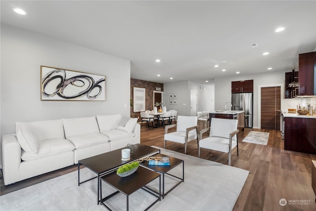 living room featuring sink and hardwood / wood-style floors