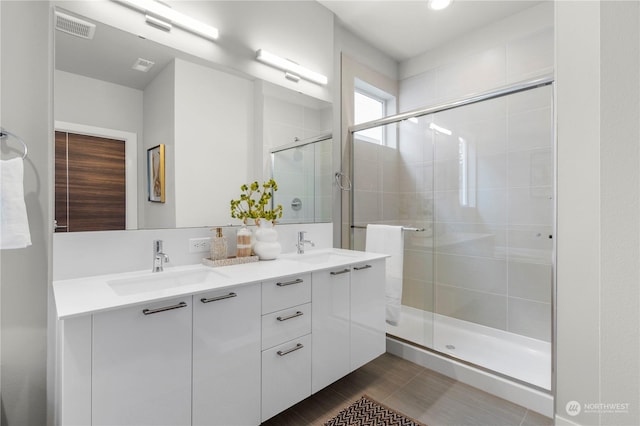 bathroom featuring vanity and a shower with door