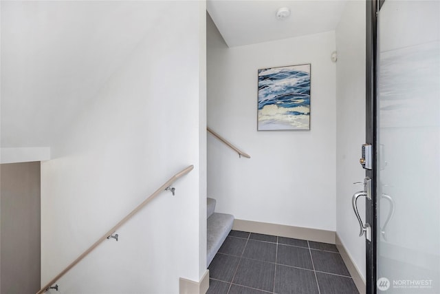 stairs featuring tile patterned flooring and baseboards