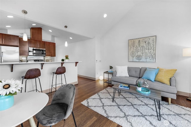 living room with lofted ceiling, baseboards, wood finished floors, and recessed lighting