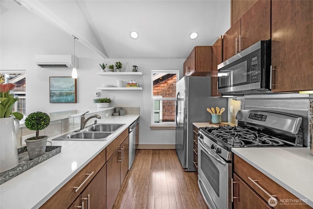 kitchen with a wall unit AC, open shelves, stainless steel appliances, a sink, and light wood-type flooring