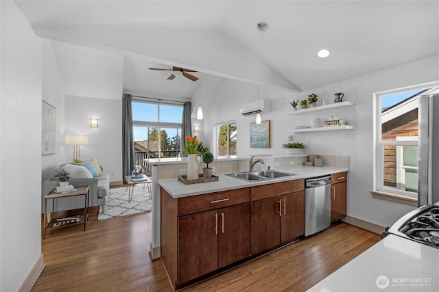 kitchen featuring dishwasher, a peninsula, a sink, and light countertops