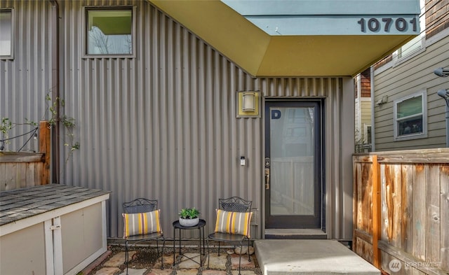 entrance to property featuring fence