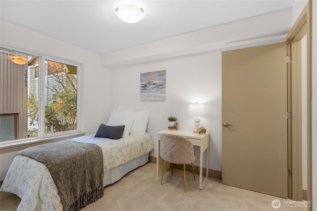 bedroom with light colored carpet