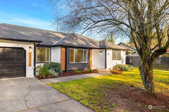 single story home featuring a garage and a front yard