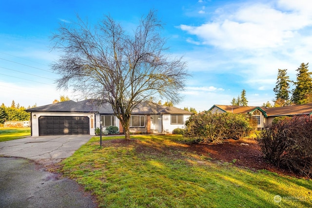 ranch-style home featuring a garage and a front yard