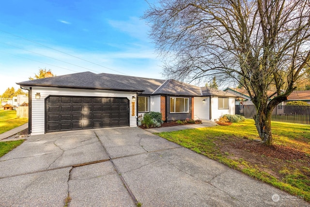 single story home featuring a garage and a front lawn