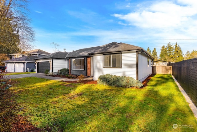 ranch-style house featuring a garage and a front lawn