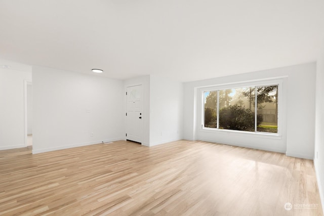 unfurnished living room with light hardwood / wood-style flooring