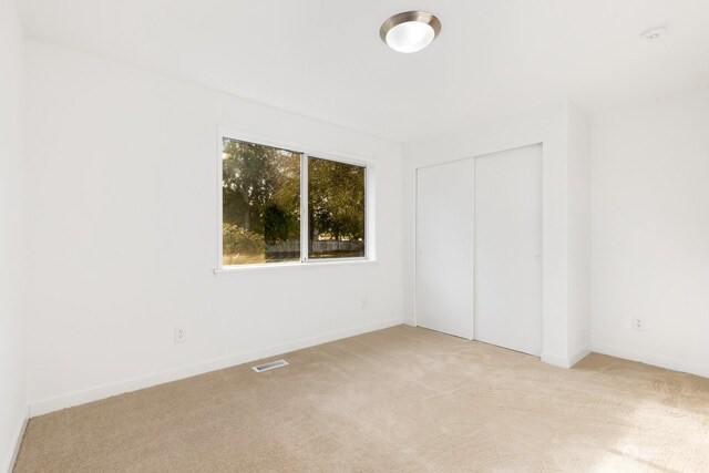 spare room with light colored carpet