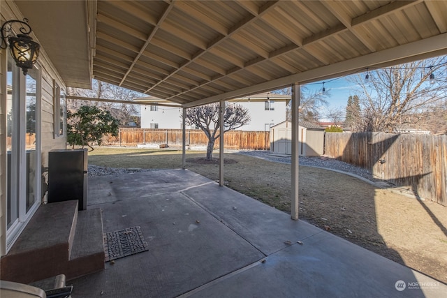 view of patio featuring a storage unit