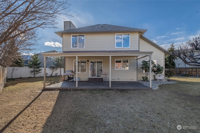 back of property featuring a lawn and a patio area