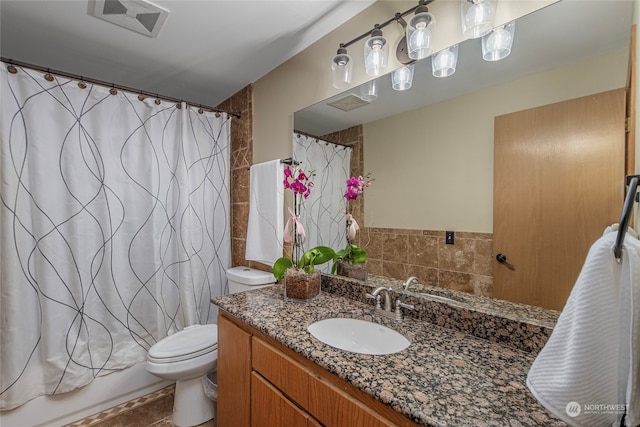 full bathroom with vanity, shower / bath combination with curtain, and toilet