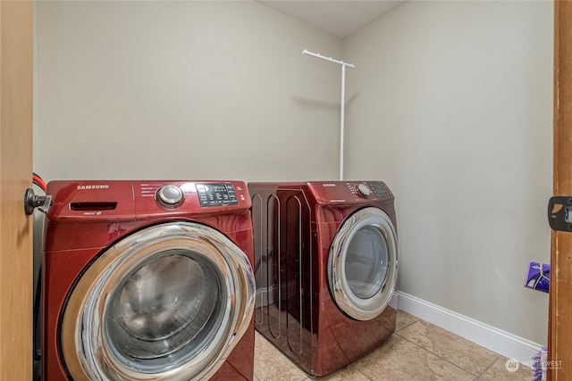 washroom with separate washer and dryer and light tile patterned floors