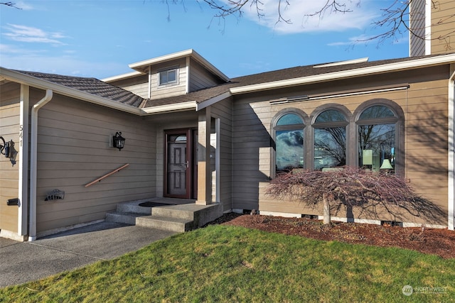 doorway to property with a yard