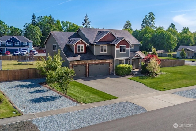 craftsman house featuring a garage and a front yard