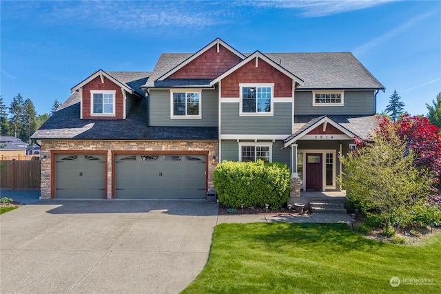 craftsman-style home with a garage and a front yard