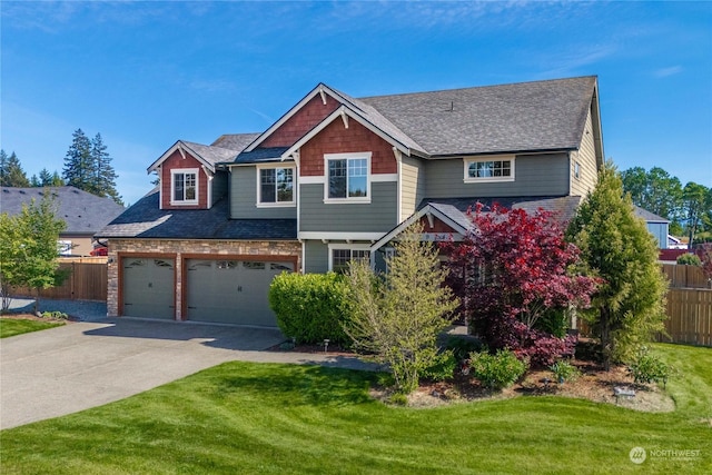 craftsman-style home with a garage and a front lawn