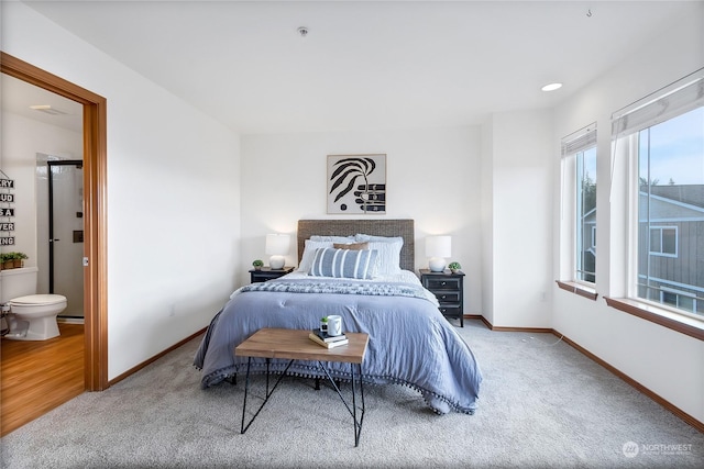 carpeted bedroom with connected bathroom