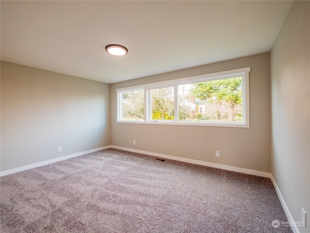 carpeted empty room featuring plenty of natural light