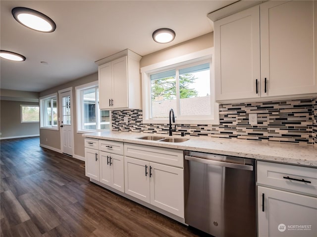 kitchen featuring dark wood-style flooring, decorative backsplash, stainless steel dishwasher, white cabinets, and a sink