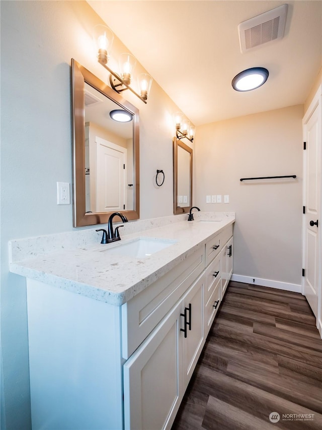 bathroom with vanity and hardwood / wood-style flooring