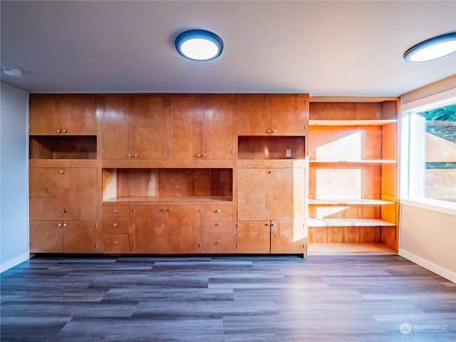 interior space with dark wood-style floors and baseboards