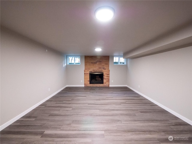 basement with wood-type flooring, plenty of natural light, and a fireplace