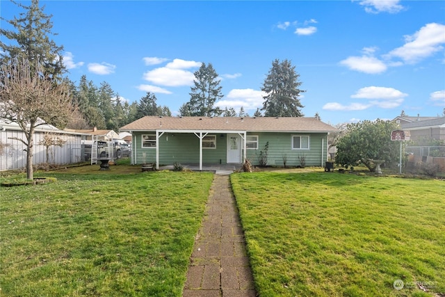 rear view of house featuring a yard and a patio