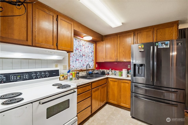 kitchen with stainless steel refrigerator with ice dispenser, sink, and double oven range