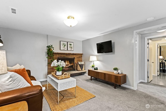 living room featuring a brick fireplace and carpet floors