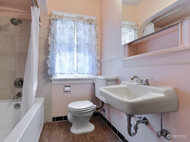 bathroom featuring shower / bath combination with curtain, wood-type flooring, and toilet