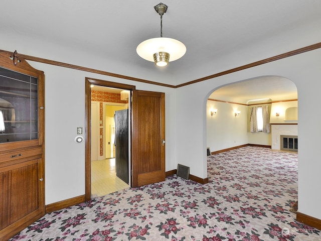 spare room with crown molding and light colored carpet