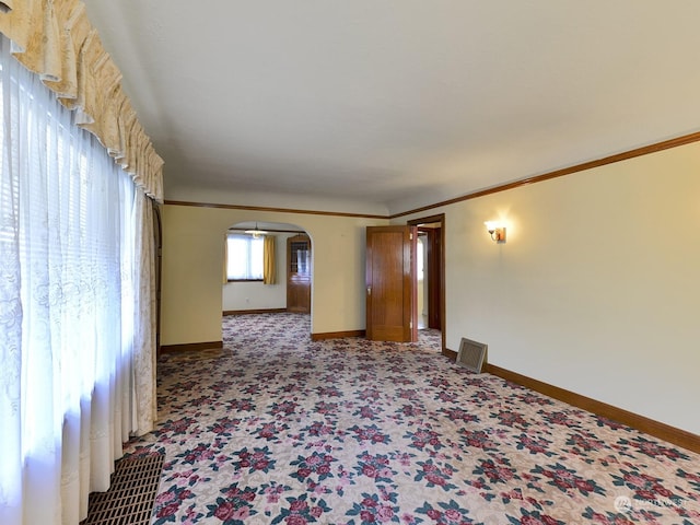 carpeted empty room with crown molding