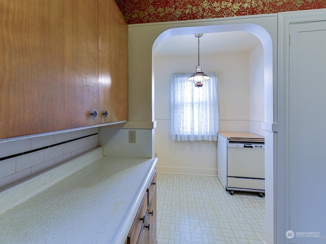 kitchen with tasteful backsplash, decorative light fixtures, and dishwasher