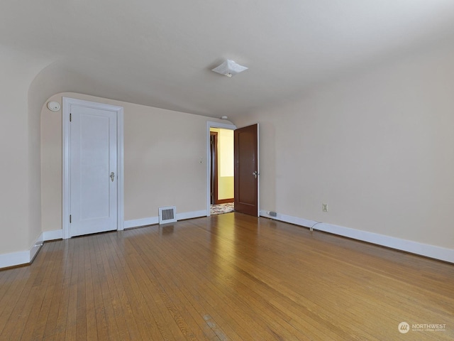 empty room with hardwood / wood-style flooring