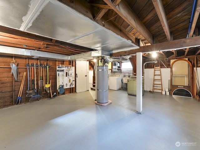 basement featuring washer and dryer and secured water heater