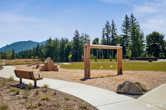 surrounding community featuring a yard and a mountain view