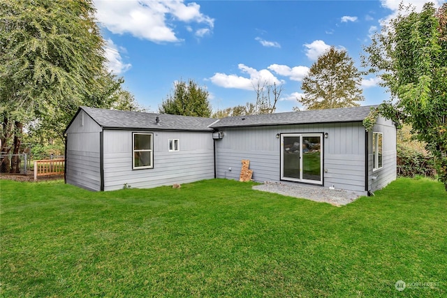 back of house with a lawn