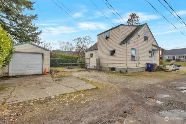 view of side of property featuring a garage and an outdoor structure