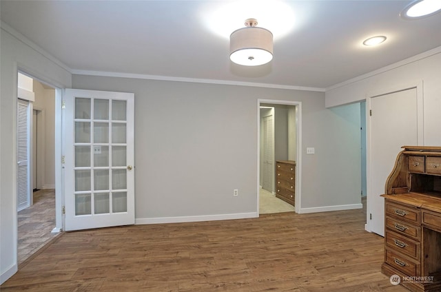 interior space with hardwood / wood-style flooring and ornamental molding