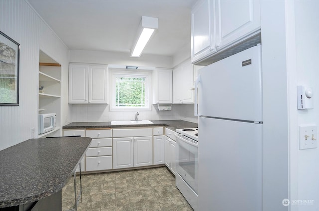 kitchen featuring sink, white cabinets, white appliances, and decorative backsplash