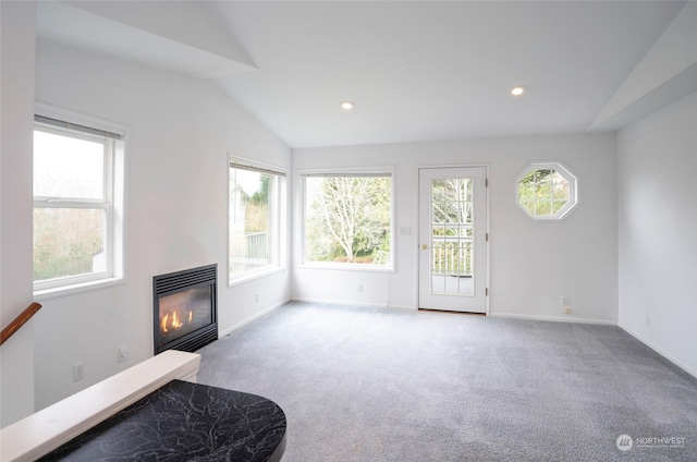 carpeted living room featuring lofted ceiling