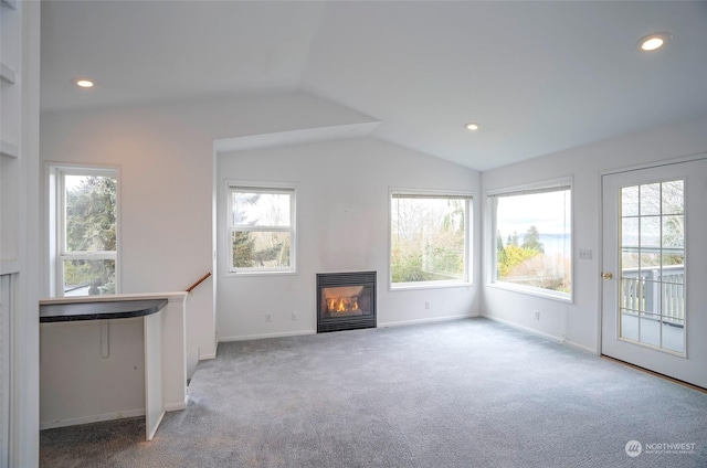 unfurnished living room featuring light carpet and vaulted ceiling