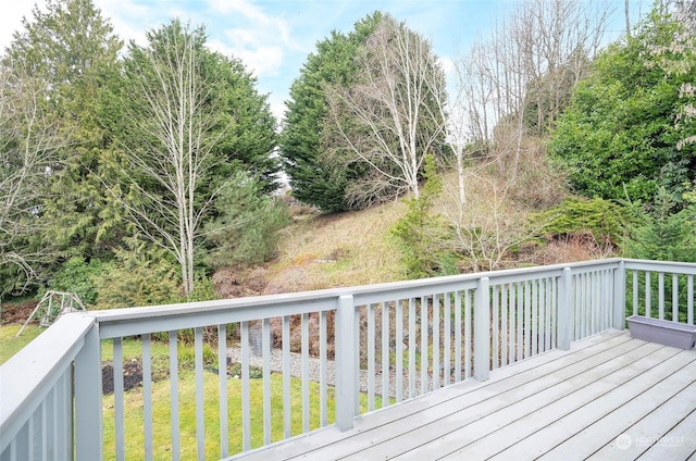 wooden deck featuring a lawn