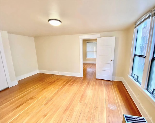 spare room featuring wood-type flooring