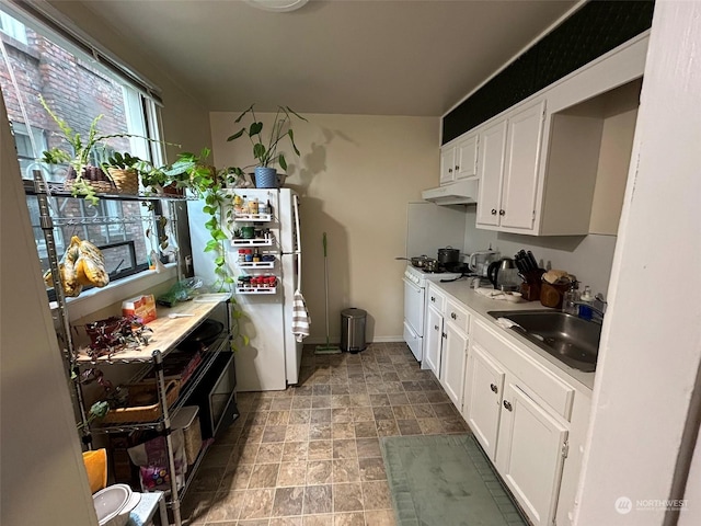 kitchen featuring white cabinetry, sink, and white appliances