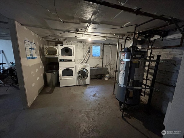 basement with strapped water heater, sink, independent washer and dryer, and stacked washing maching and dryer