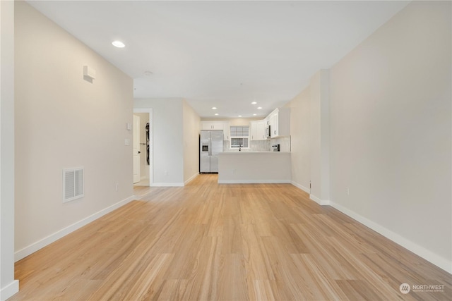 unfurnished living room with light wood-type flooring