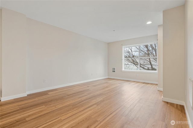 spare room with light hardwood / wood-style floors